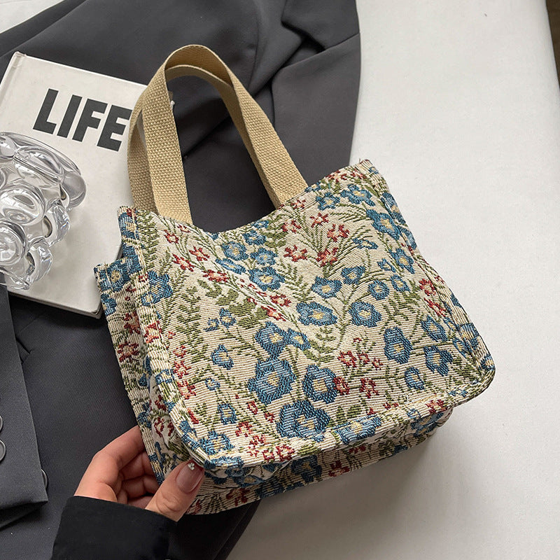 Damentasche mit floralem Stickdesign und robusten Hän handles