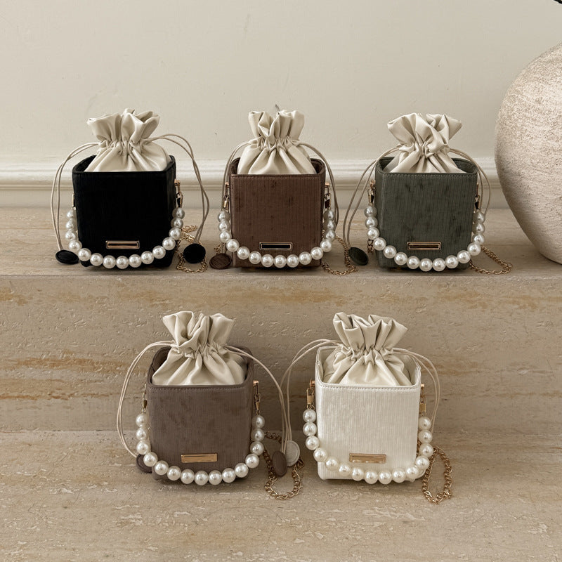 Damen stilvolle Mini-Handtasche mit Kordelzug und Perlenakzent
